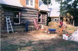 Jim chinking. Bud mixing mud.